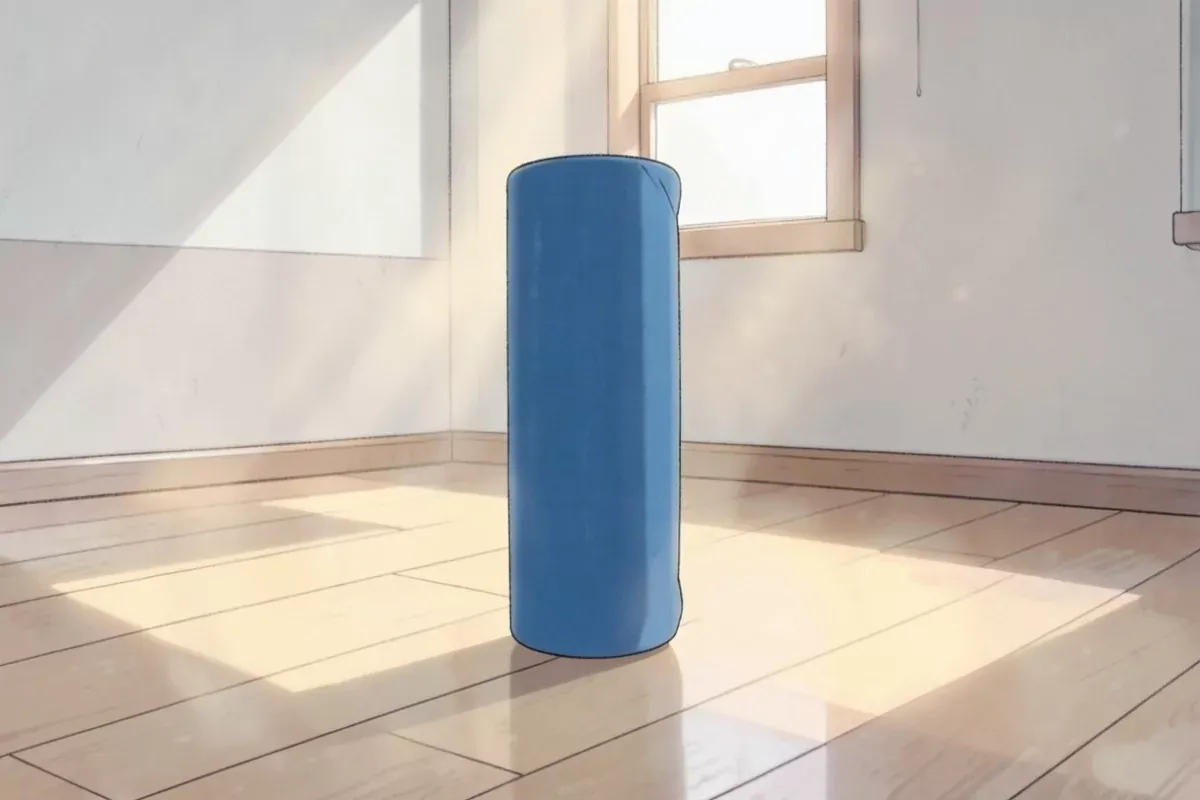 A blue foam roller standing upright on a wooden gym floor