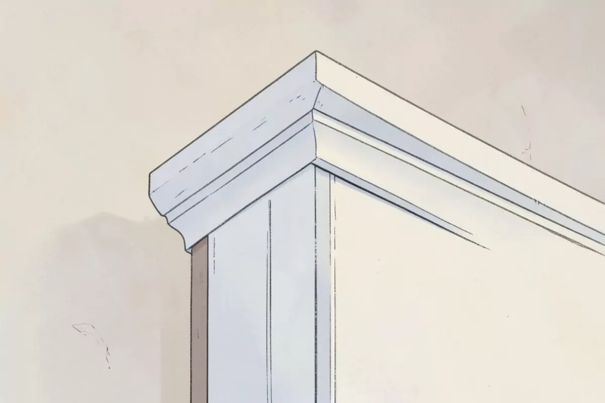 A close view of the decorative trim moulding at the top corner of a white door frame